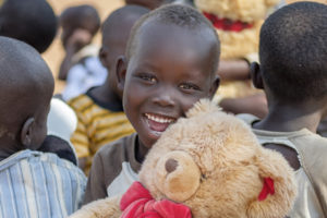 Julia Towango, 4, shows his excitement after receiving a Teddy Bear at Imvepi Refugee Settlement in Arua District in Northern Uganda 1 December 2017.